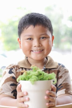 The boy is happy. With small trees.