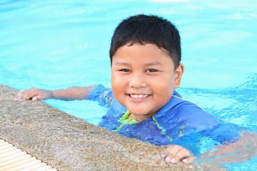 The boy was swimming in the pool.