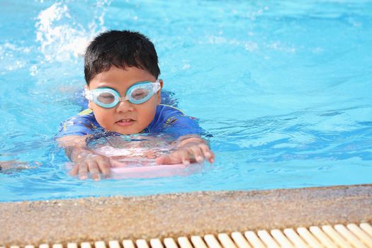 The boys were playing in the swimming pool.