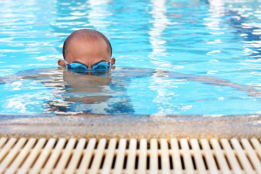 Bald men are swimming.