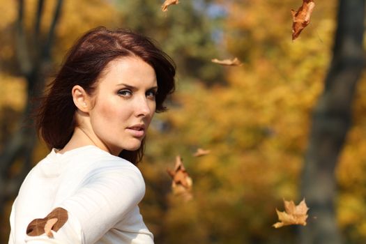 Portrait of a happy woman against yellow leaves