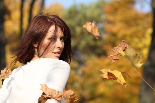 Portrait of a happy woman against yellow leaves