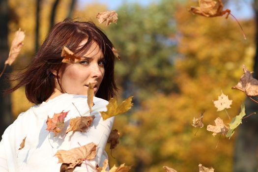Portrait of a happy woman against yellow leaves