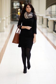 beautiful young woman waling in the shop