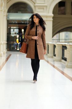 beautiful young woman waling in the shop