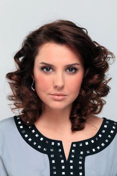 Beautiful young woman in gray background