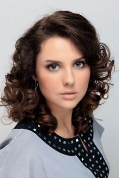 Beautiful young woman in gray background