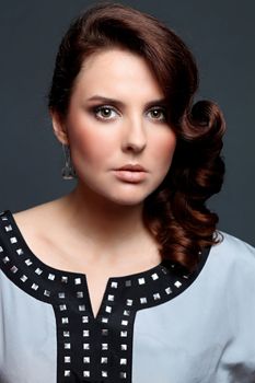 Beautiful young woman in gray background