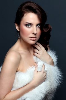 Beautiful young woman in gray background
