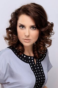 Beautiful young woman in gray background