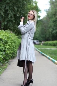 beautiful young woman business woman in a gray cloak