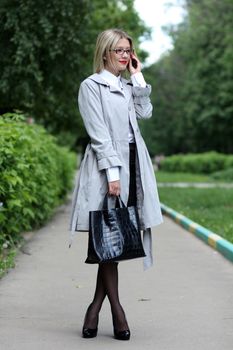 beautiful young woman business woman in a gray cloak
