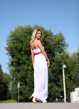 Lady in white dress in the street summer