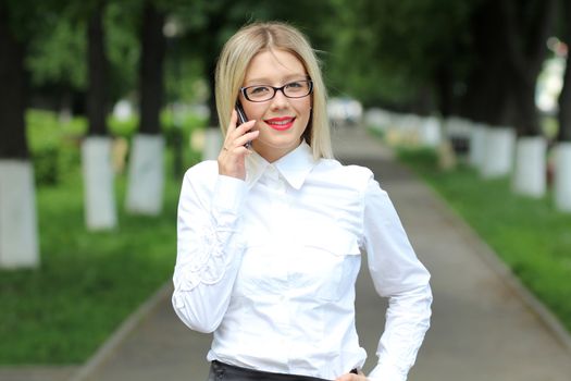 Happy young lady talking on mobile phone