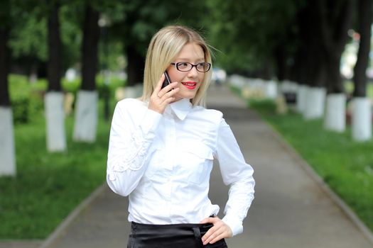 Happy young lady talking on mobile phone