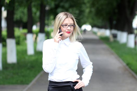 Happy young lady talking on mobile phone