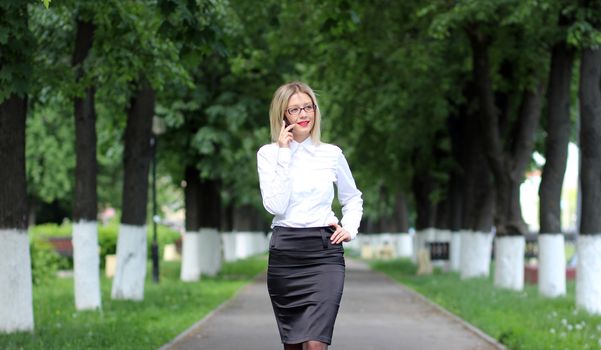 Happy young lady talking on mobile phone