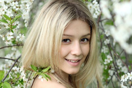 Portrait of beautiful blond in spring blossom
