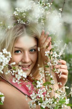 Portrait of beautiful blond in spring blossom
