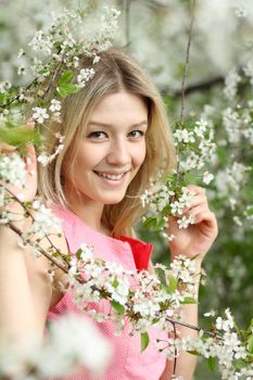Portrait of beautiful blond in spring blossom