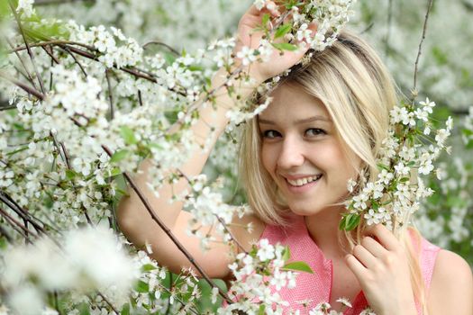 Portrait of beautiful blond in spring blossom