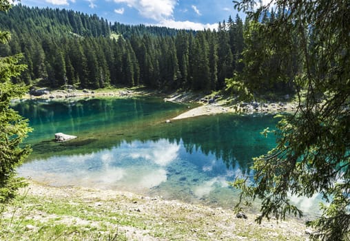 reflections in the famous lake of Carezza - Dolomites, Italy