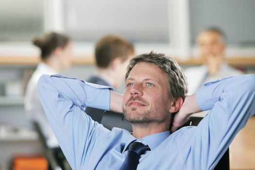 Portrait of a relaxed Businessman, business meeting on background