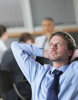 Portrait of a thoughtful Businessman, business meeting on background