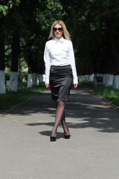 Cute businesswoman walking on the street