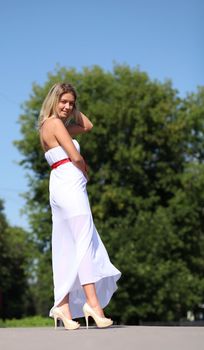 Lady in white dress in the street summer