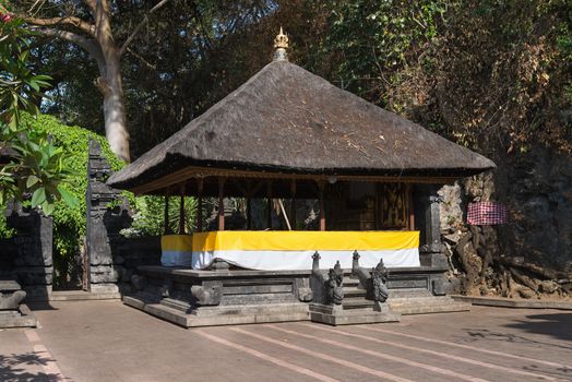 Traditional Balinese pavilion Bale Piasan for offerings in Goa Lawah Bat Cave