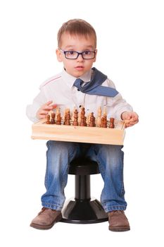 Serious kid playing chess, isolated on white background. 