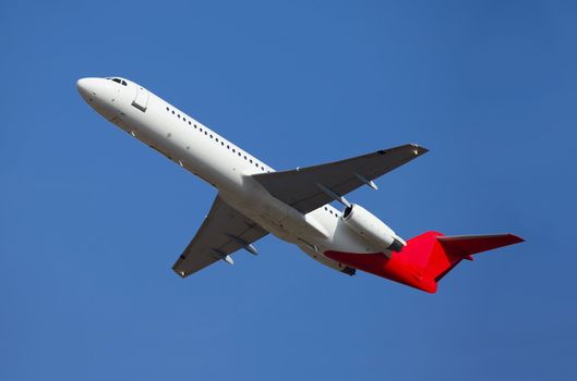 Airplane flying away to the blue sky