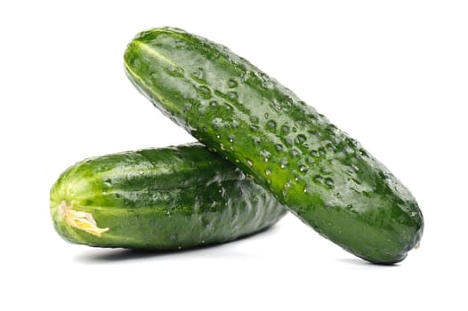 Two whole ripe cucumbers on white background
