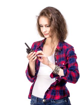 Attractive young woman in a checkered shirt with walkie talkie, isolated