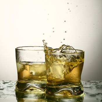 whiskey splash close up in dark