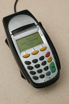 A eftpos machine on a plain background