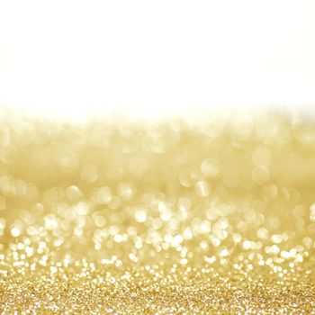 Golden shiny glitter holiday celebration background with white copy space