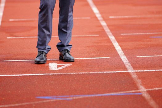 Businessman standing on the start line close up of shoes