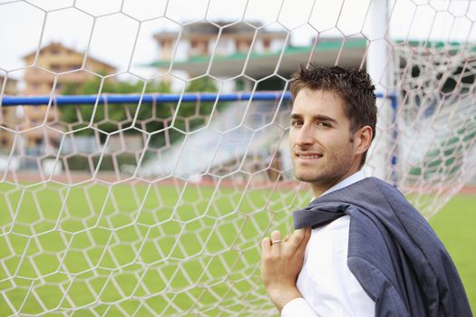 Portrait of a football coach or player near the soccer goal