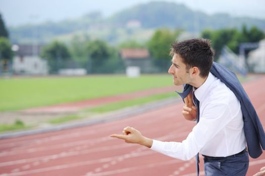 Football coach giving instructions to his team