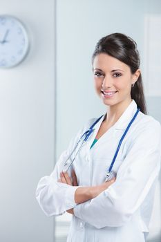 Portrait of a smiling woman doctor with her arms crossed