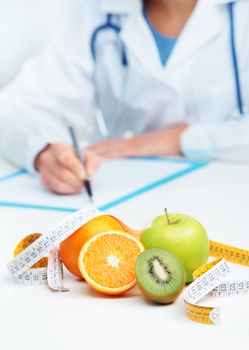 Nutritionist Doctor is writing a prescription. Focus on fruit