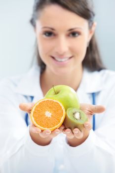 Nutritionist Doctor holding some fruits in her hand