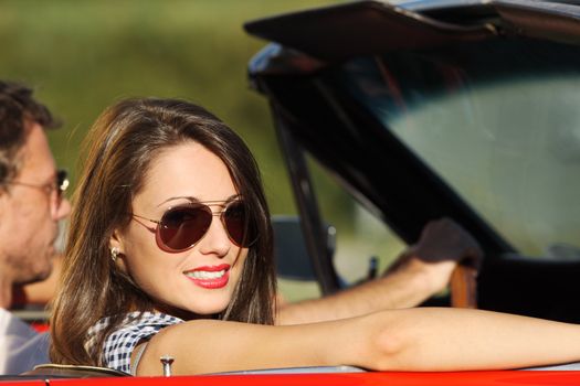 Portrait of a couple in a convertible car on a sunny day