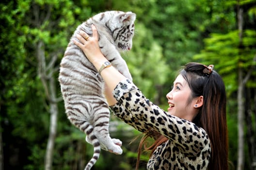 pretty women hold baby white bengal tiger