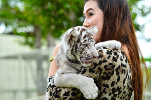 pretty women hold baby white bengal tiger