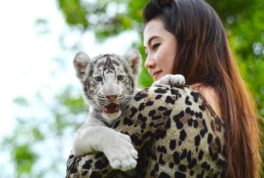 pretty women hold baby white bengal tiger