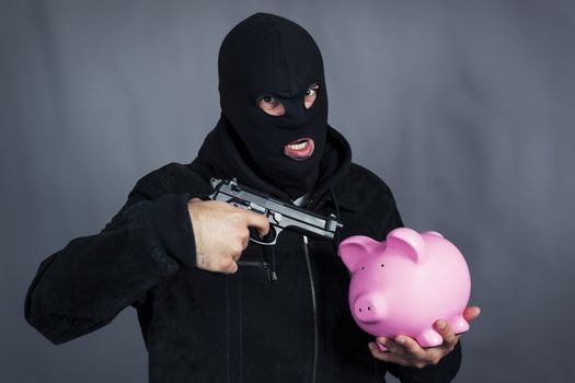 Man with gun on ping piggy bank