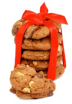 Stack of Delicious Christmas Cookies with Chocolate Pieces and Nuts Tied with Red Ribbon isolated on white background